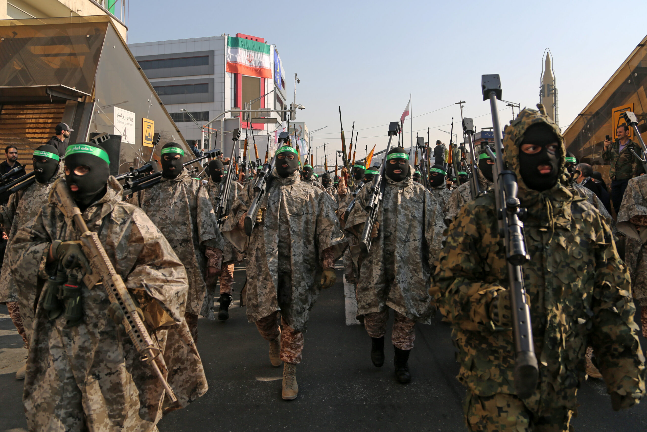 TEHRAN, IRAN - JANUARY 10: Hundreds of Iraninan carrying banners take part in a demonstration against Israel and the United States as they march through Enghelab Street in capital city Tehran, Iran on January 10, 2025. A march was organized by the Revolutionary Guards and Basij, the militia of the Islamic Revolutionary Guards Corps (IRGC). Thousands of men and women who identify themselves as 'Basij Volunteers' marched in the parade. Carrying Palestinian and Iranian flags, the group chanted slogans against Israel and the United States. (Photo by Fatemeh Bahrami/Anadolu via Getty Images)