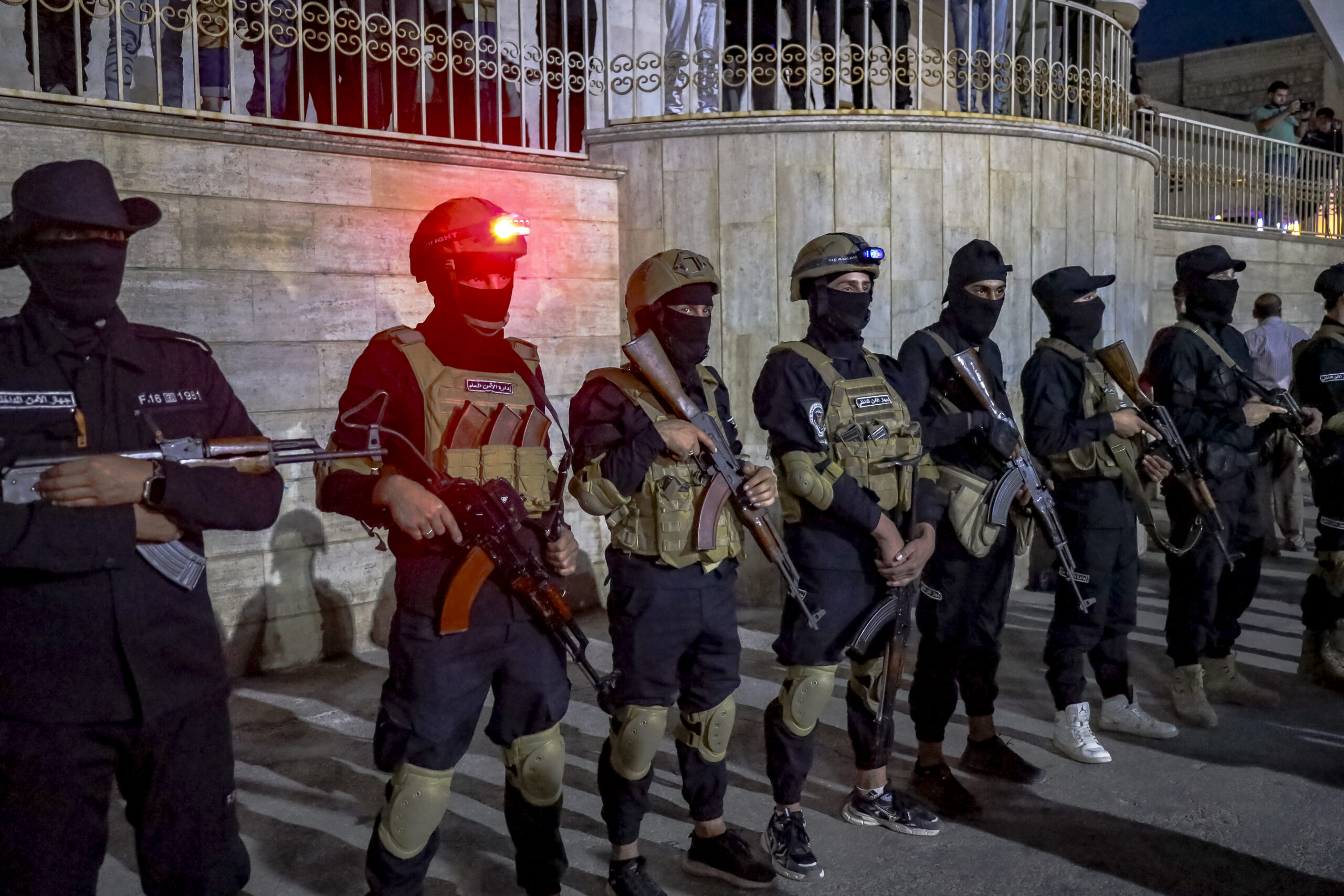 Masked and armed Syrian security personnel are on the scene as people gather in Idlib, Syria, on July 16, 2025 to voice their support for the operations by the new Syrian government and its forces in Sweida. Hundreds of people have been killed in Syria as government forces attacked the Druze in Sweida. (Photo by Omar Albaw / Middle East Images via AFP) (Photo by OMAR ALBAW/Middle East Images/AFP via Getty Images)