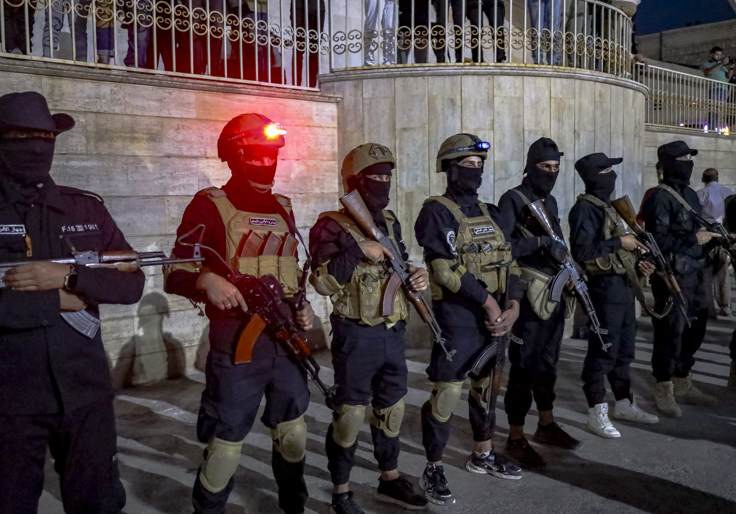 Masked and armed Syrian security personnel are on the scene as people gather in Idlib, Syria, on July 16, 2025 to voice their support for the operations by the new Syrian government and its forces in Sweida. Hundreds of people have been killed in Syria as government forces attacked the Druze in Sweida. (Photo by Omar Albaw / Middle East Images via AFP) (Photo by OMAR ALBAW/Middle East Images/AFP via Getty Images)