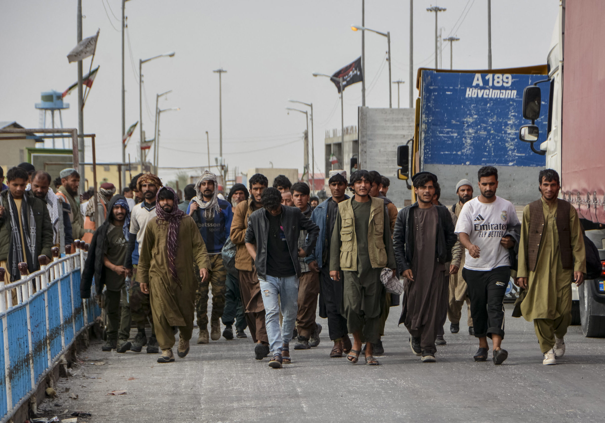 Afghan nationals walk upon their arrival from Iran at the Pul-e Abresham, or the Silk Bridge, at the Zero Point crossing between Afghanistan and Iran, in Zaranj, Nimruz province on March 5, 2026. Since US and Israeli strikes on February 28 triggered a regional war, Afghans crossing the border said they had left a frightening situation behind them. (Photo by AFP via Getty Images)